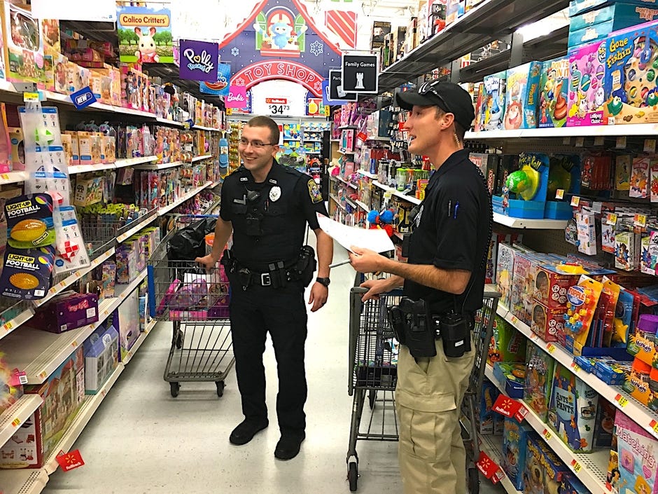 Crestview Police Officers Justin Wallen and Gabe Dunlap shop for childrenís toys for the agencyís Cops For Kids program. [BRIAN HUGHES | CRESTVIEW POLICE DEPARTMENT]