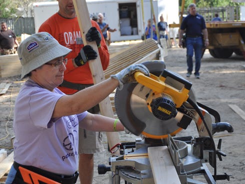 North Carolina resident Dottie Birch uses a table saw during the Okaloosa County Habitat for Humanity’s ‘Blitz Build’ on Friday. Dottie and her husband Bob were among the nearly 240 volunteers to participate in constructing a Crestview residential home over the weekend.