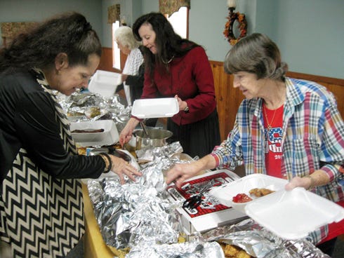 Holt Assembly of God Senior Fellowship Ministry members Linda Clayton, Brenda Russell and Maureen Sanford prepare meals for shut-ins before the church’s November luncheon.