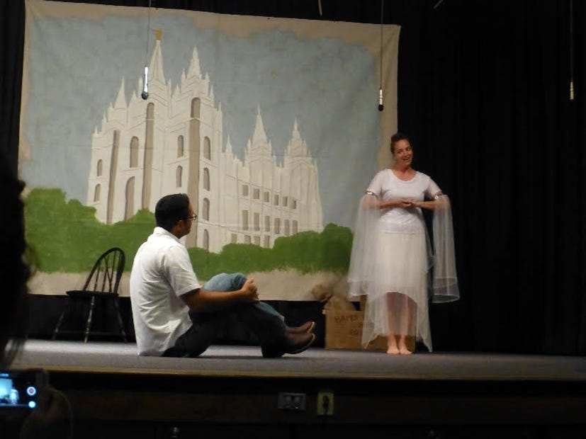 Angel Emily Curtis sings “Pioneer Dropout,” based on "Beauty School Dropout" from the musical, "Grease") to Felipe De Freitas who played the part of Danny. In the LDS version, Danny could not decide between staying in Nauvoo, Illinois, or go west with Sandy and the pioneers until the angel sang to him in a dream. The performance was part of the Church of Jesus Christ of Latter-Day Saints Pioneer Day celebration July 23 in Fort Walton Beach.