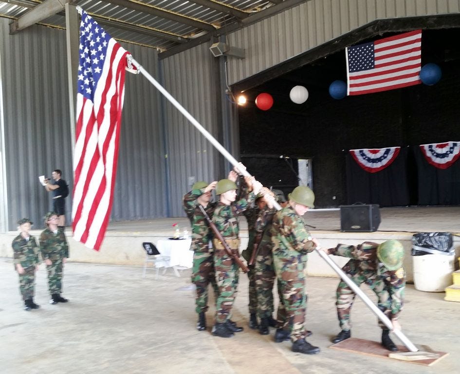 Members of the Emerald Coast Young Marines re-enact the flag raising at Iwo Jima, a stirring World War II photograph that captured five Marines and one Navy corpsman raising the U.S. flag on Mount Suribachi.