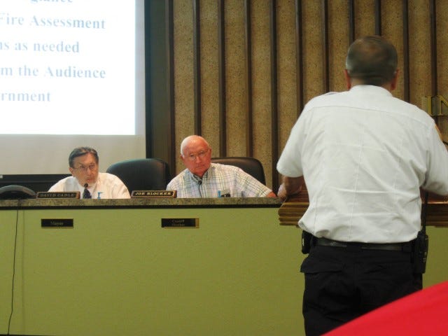 Mayor David Cadle listens as Crestview City Councilman Joe Blocker questions Fire Chief Joe Traylor about a proposed fire assessment fee at the July 6 workshop.