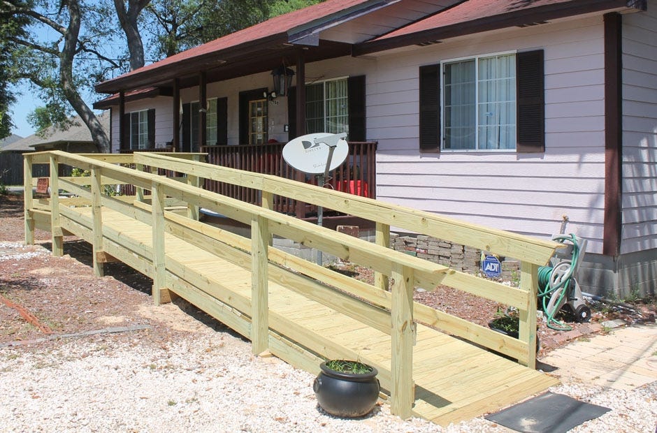 Volunteers during a previous Faith in Action event put on by Woodbine United Methodist Church built this ramp for a local elderly couple. [FILE PHOTO]