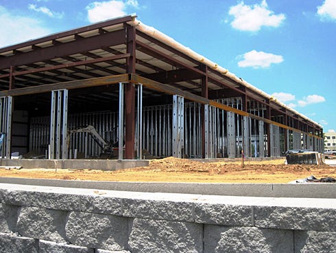 The Crestview City Council is questioning whether a traffic impact fee waiver, set to expire at the end of the year, encouraged developers to pursue Redstone Plaza — pictured rising in May — and similar projects.