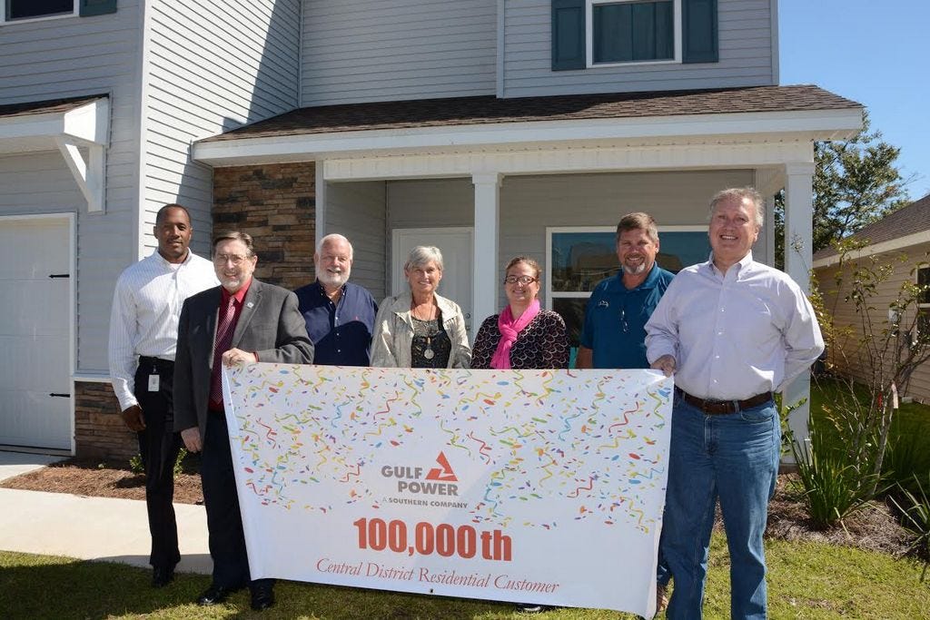 Joining in the celebration are, from left, Bernard Johnson, Gulf Power District general manager; Crestview Mayor David Cadle; homebuilders Bob and Mary Fisher; homeowner Leah Nash; builder Bobby Fisher; and Okaloosa County District 1 Commissioner Wayne Harris.