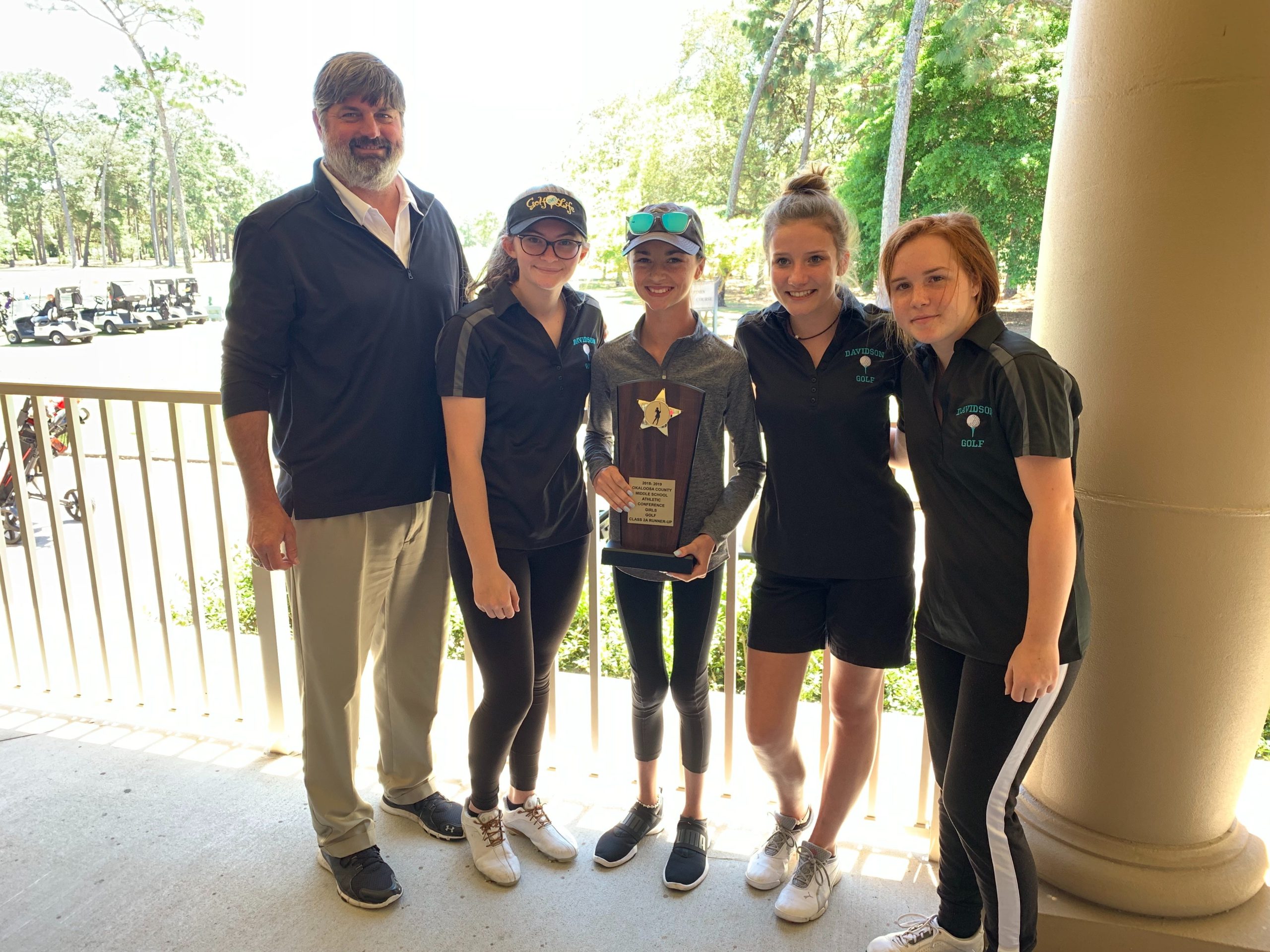 Davidson's golf team and coach pose with Gracie Grant after her victory on Monday. [CONTRIBUTED PHOTO]