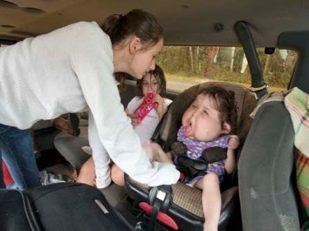 Megan Renfroe prepares her sister Katie for the 12-hour drive to Hollywood, Fla., where she is receiving a series of surgeries to improve the quality of her life.