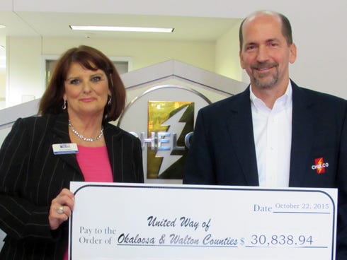 Steve Rhodes, CHELCO's DeFuniak Springs CEO, presents a $30,838.94 check to Ronda Davenport of the United Way of Okaloosa and Walton Counties. The company participated in the UW Pacesetter Campaign.
