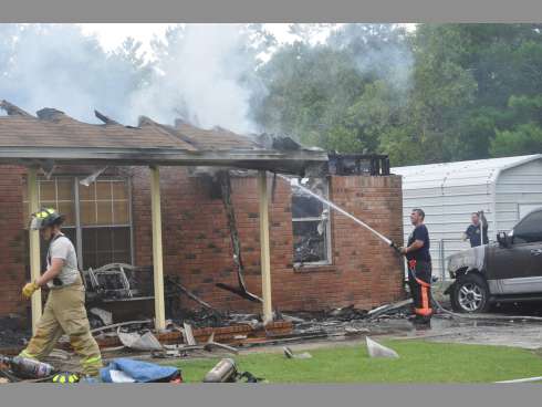 Dorcas volunteer firefighters extinguish flames at 3939 Painter Branch Road. No was injured in the fire, but fire officials said lightening may be to blame.