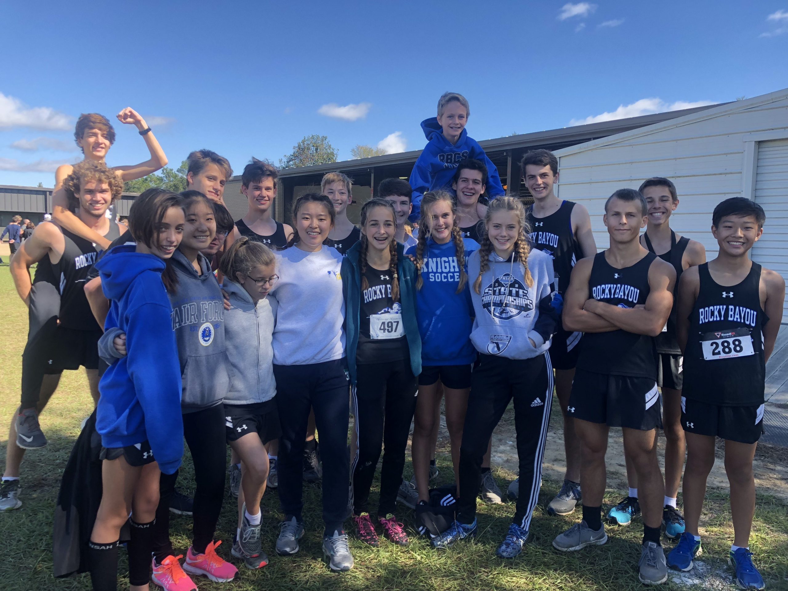 Members of the Rocky Bayou cross country team pose together after completing a meet in Pace. [FILE PHOTO]