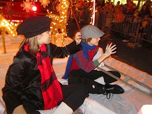 Twins Elissa and Eli Reid, then 11, wave to the crowd from the News Bulletin’s float during the 2011 Crestview Christmas Parade. This year’s parade theme is “Blessed are the Children.”