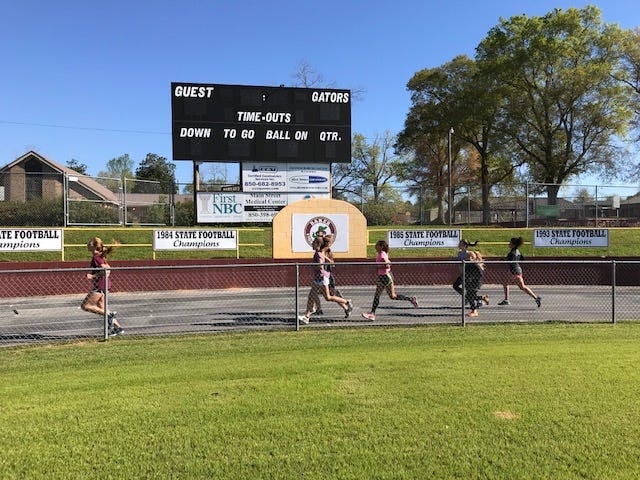 Members of Baker's track & field team practice for an upcoming meet. [FILE PHOTO]