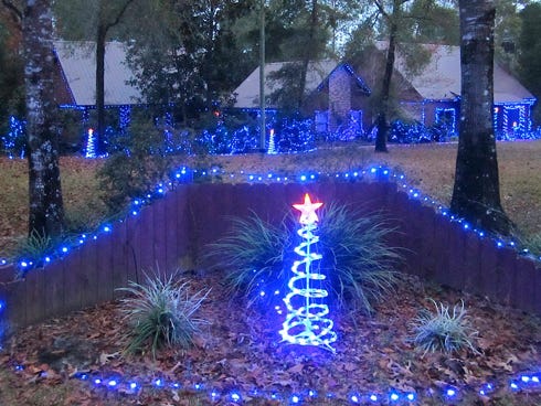 Lights outlining this Old Bethel Road country home cast a blue glow in the distance as motorists approach.