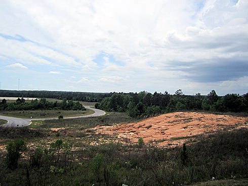 The bank that owns this property, the site of a proposed shopping mall, has suddenly agreed to grant the city easements on which to construct a 15-inch sewer line.