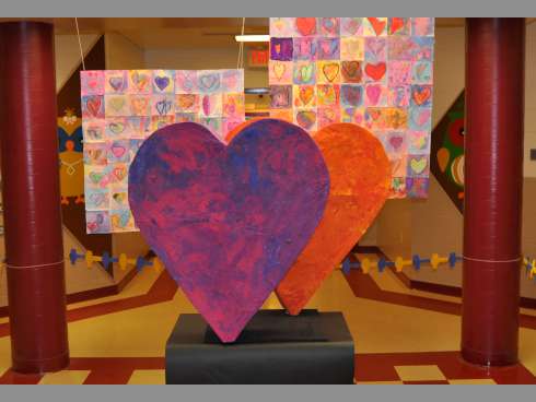 Two large papier-mché hearts sit as the centerpiece in Tuesday night's Spring Art Show at Walker Elementary School. The project was a collaborative effort from the school’s eight kindergarten classes. The show featured artwork from every student at the school.