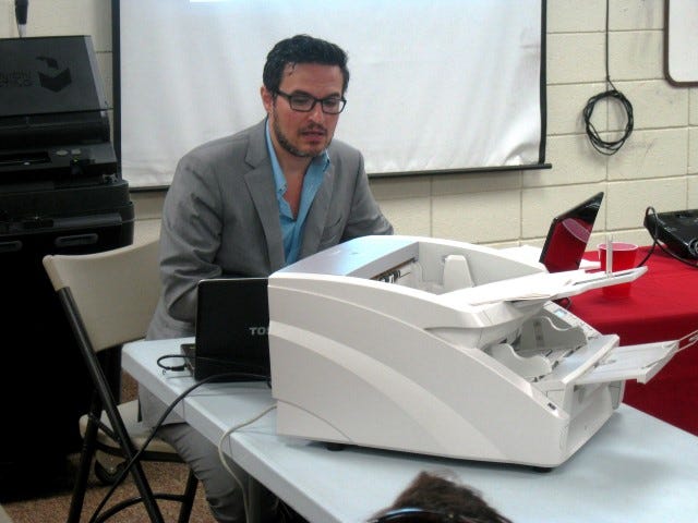 Dominion Voting Systems representative Peter Androutsos demonstrates his company’s tabulating system to the Okaloosa County Supervisor of Elections equipment review board.