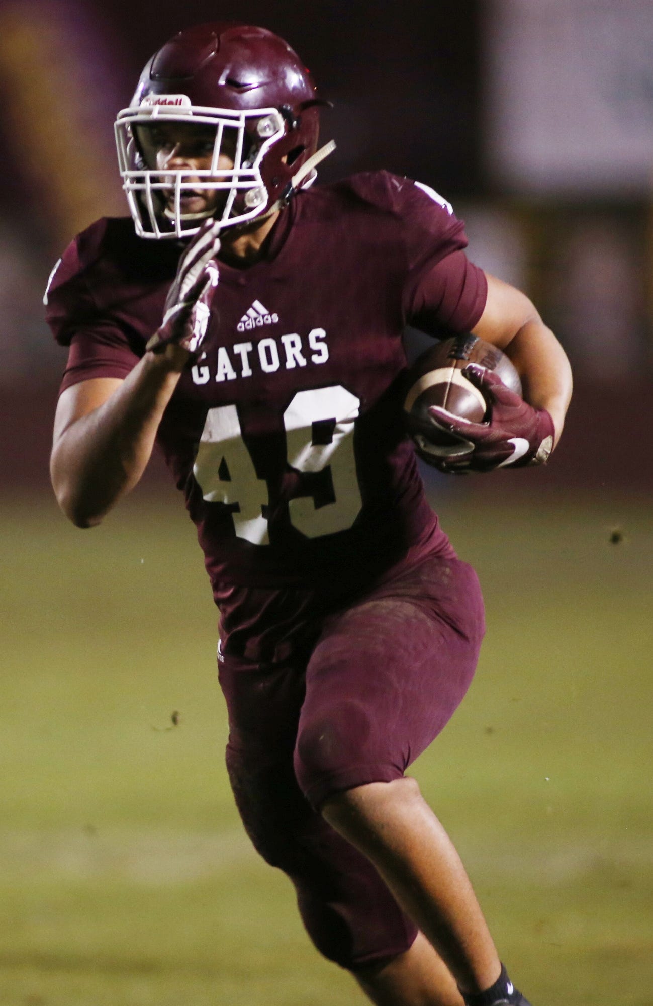 Baker junior Eric McQueen carries the ball in a Baker playoff game. [FILE PHOTO]