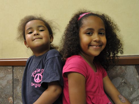 Samantha Redmond, 4, and her sister, Madeline, 6, are acting in online skits to raise funds for a July 27 children's pageant in Mississippi.