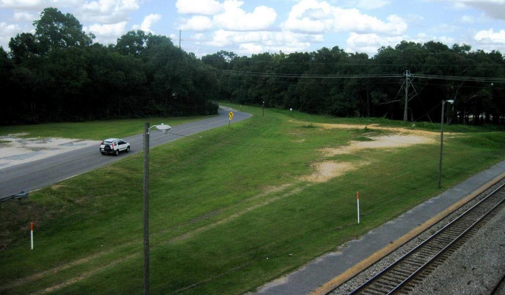 Industrial Drive — pictured between city-owned properties east of the State Road 85 railroad overpass — will be renamed Crestview Junction, up to the curve, under a proposal approved by the Community Redevelopment Agency. A recreation of the Crestview depot would be built on the site between the road and the railway tracks.