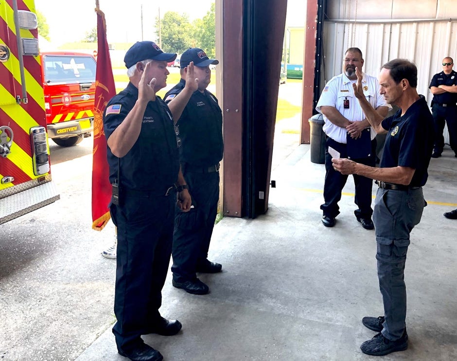As Crestview Fire Chief Tony Holland observes, Mayor JB Whitten swears newly promoted fire Capt. Dennis Folkerts and Lt. Nicholas Stowell into their new ranks July 31 in Crestview. [SPECIAL TO GATEHOUSE MEDIA FLORIDA]
