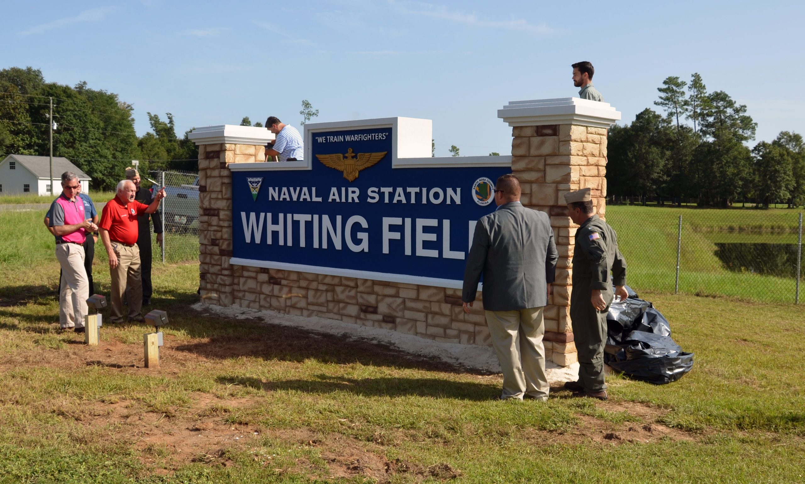 Commissioners Don Salter and Commissioner Sam Parker make sure everything is in place before the unveiling. [CONTRIBUTED PICTURE]