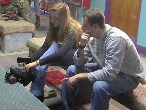 Briana and Matt Smith change into roller skates before joining the fun of Old School Night at SkateTopia.