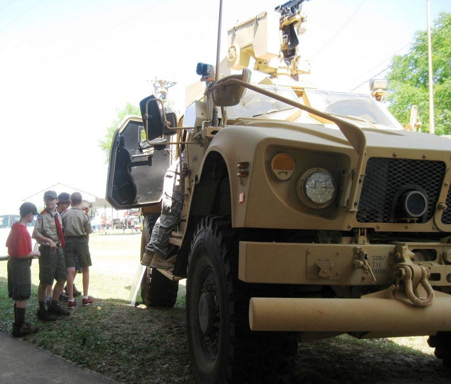 Boy Scouts from Crestview Troop 30 stand beside a 7th Special Forces Group (Airborne) 12.5-ton armored vehicle during the 2014 Military Appreciation Recognition Celebration. This year's MARC is also expected to include military static displays.