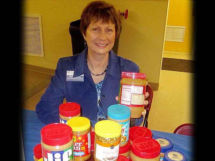University of Florida/Institute of Food and Agricultural Sciences extension agent Elaine Courtney displays some of the nearly 300 jars of peanut butter that Crestview area residents donated. The Florida Peanut Producers Association will match the donations, ounce for ounce, and give them to Sharing and Caring and local church soup kitchens.
