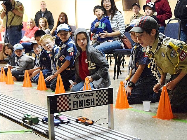 Crestview Pack 530 Cub Scouts and Webelos cheer on racers during during the Jan. 31 Pinewood Derby.