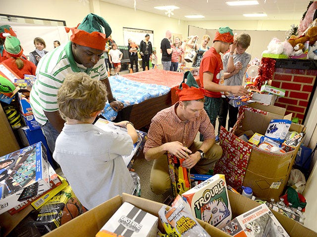 “Santa's Elves" — as organizers of the Emerald Coast Christmas Miracle Needy Children's Fiesta call them — help sort donated gifts for 2013 attendees. This year's Dec. 19 event is expected to attract families from all over Northwest Florida and even Alabama, Crestview resident Estela Elias, event vice chair, said.