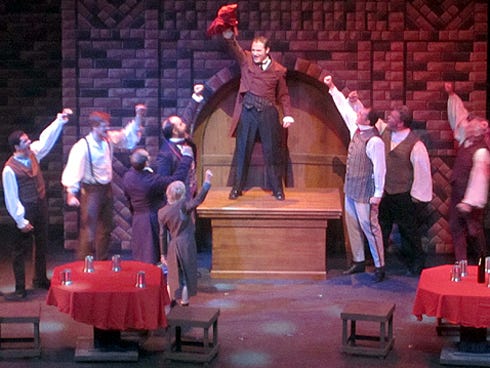 Tim Norton, center, portrays Enjolras, who rallies his classmates to man the barricade for the Republican cause in "Les Misérables."