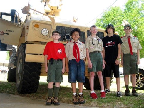 Crestview Troop 30 Boy Scouts line up to provide a sense of scale to a 7th Special Forces Group (Airborne) 12.5-ton armored vehicle. From left are Bradley Johnston, Joshua Valdez, Zack Livingston, Jonathon Rodriguez and Aiden Finney.