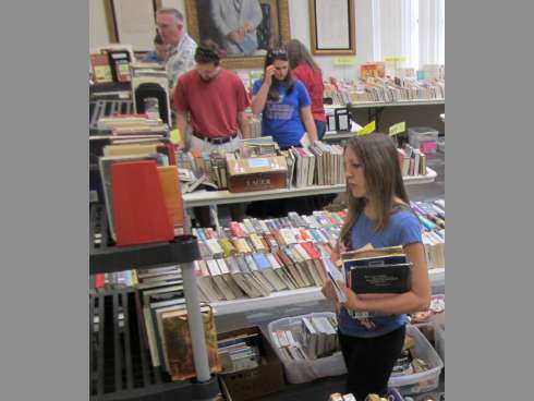Visitors eye the selection at last year's Friends of the Library book sale. This year’s spring sale runs April 5-7.
