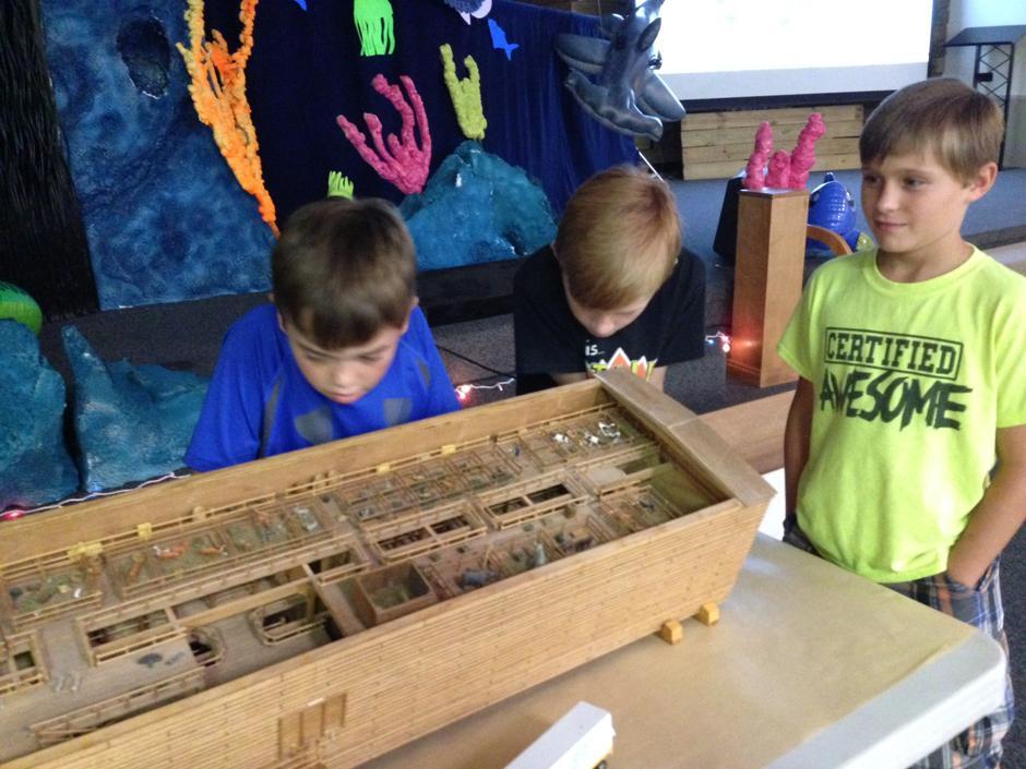 Benny Bears, Chase Nixon and Jessie Nixon admire an almost 7-foot-long ark model during Vacation Bible School at Joy Fellowship.