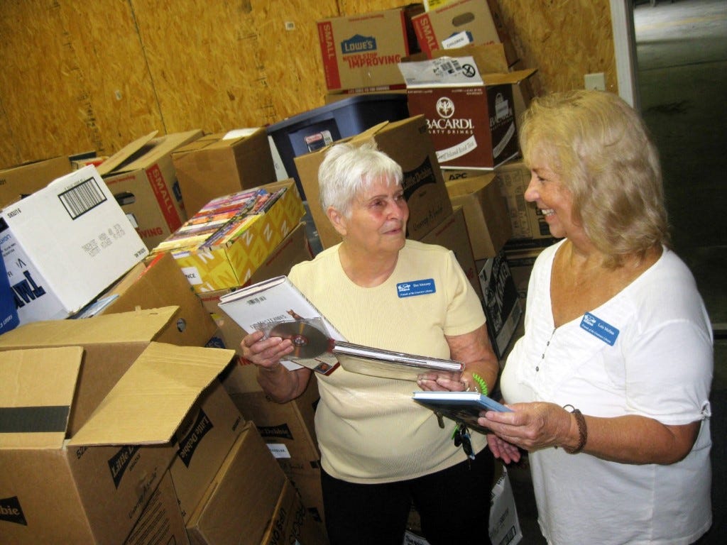 Friends of the Library Book Sale chairwoman Dot Moxcey and volunteer Lois Molina sort through books Monday afternoon in preparation for the fall Friends of the Library Book Sale.