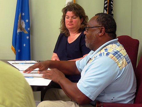 As newly sworn-in Councilwoman Debra Adams listens, Laurel Hill City Councilman Johnny James explains he did not run for office knowing he lived outside of the city limits.