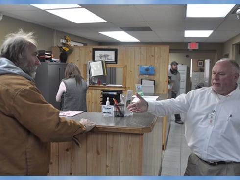 Crestview Public Services Director Wayne Steele, right, speaks to Cecil Milstead at the public services department. Steele presented employees’ donations to Milstead, who lost his home to a Dec. 19 fire.