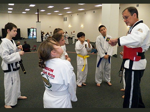 Greg Bledsoe, right, teaches students, from left, Matthew Wilkinson, Asline Heringer, Lilly Balch, Marissa Taylor, Jayden Duarte, Bryce Bostjanick, and Braden Taylor how to beat bullies and performs punching drills.