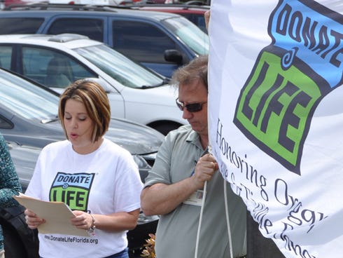 Lesley Lang from LifeNet Health of Florida shares a thank-you letter from a local organ transplant recipient at a brief flag raising ceremony at the North Okaloosa Medical Center. Throughout April, NOMC is spreading awareness about the need for organ, eye and tissue donations.
