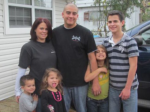 The Chandler family stands outside their Crestview residence. From the left on top are Christine, Charles, Marissa and Eric. At the bottom are Lucas and Madalyn. Christine seeks the community's assistance in repairing her husband's vehicle before he returns from a five-month deployment in Afghanistan