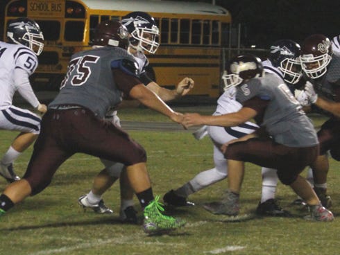 Baker defenders swarm to the ball against Walton earlier this season. The Gators defense will try to slow down a potent South Walton offense on Friday.