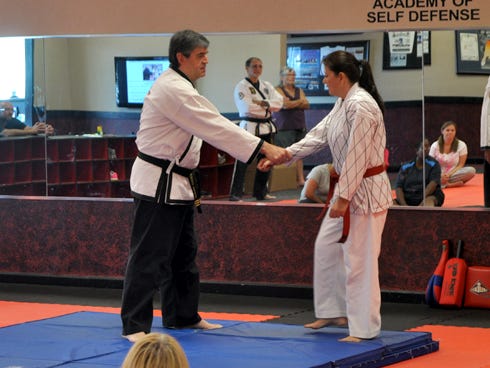 Gordon Martial Arts instructor Alberto Barbon and student Barbara Wimberley demonstrate life-saving moves during a previous women's self-defense course.