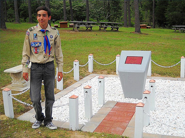 Crestview Troop 773 Boy Scout Austin Carrico stands next to the refurbished memorial at Krul Lake State Recreation Area. For his Eagle Scout leadership project, Austin designed and supervised refurbishment of several Krul Lake facilities.