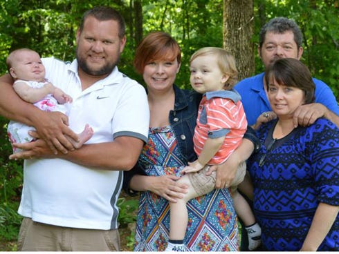 Angie Pinkerton, far right, and her husband, Andy, appear with the Long family in a recent family photo. Holt Academy, Pinkerton’s former employer, recently donated more than $1,600 to aid her grandson, Jaxon, in his fight against acute lymphocytic leukemia. From the left are Jimmy Long, holding baby Sawyer and Tiffany holding Jaxon.