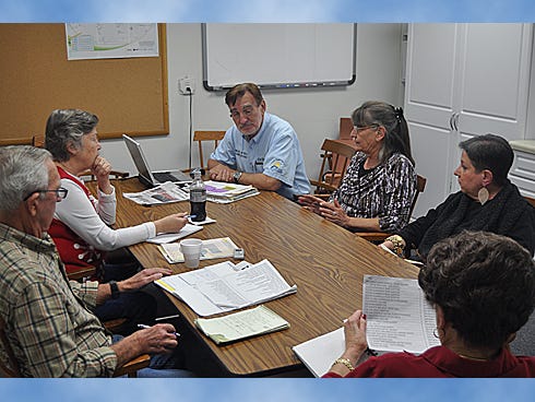 Main Street Crestview Association members, including President Ellis Conner, Patti Gonzo, Cal Zethmayr, Viola Owens, Rae Schwartz and Pat Hollarn discuss possible ways to include controversial applicants in future Christmas parades. Dec. 1, a parade entrant who shouted obscenities at the crowd and denied Santa Claus’ existence, caused widespread outrage among residents.