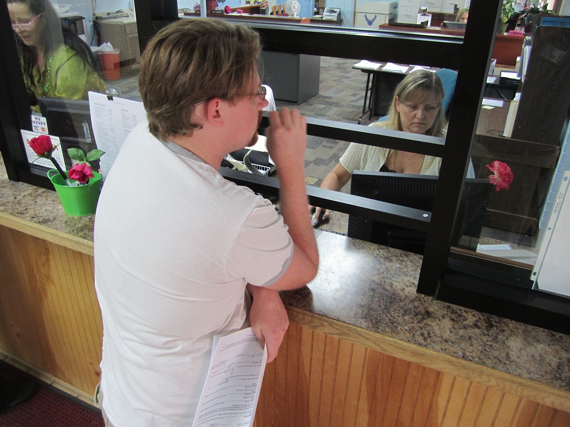 Billing clerk Tammie Godwin helps Forrest Jenkins establish water service at his new Crestview residence.