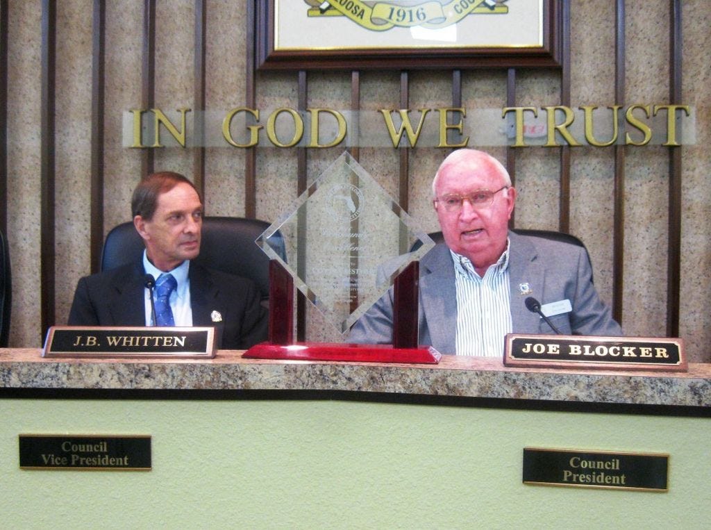 Crestview City Council Vice President JB Whitten and President Joe Blocker show the Northwest Florida League of Cities’ Community Excellence Award to city leaders and residents during the May 23 City Council meeting.