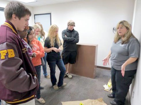 Okaloosa County Sheriff's Office investigator Lisa Hughey speaks to students during a presentation on law enforcement careers.