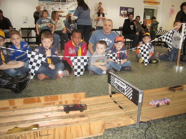 Pack 799 Cub Scouts and their families closely watch the finish line during the Feb. 8 Pinewood Derby races at Bob Sikes Elementary School.