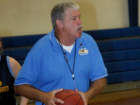 Ronnie Smith instructs Laurel Hill School's girls basketball team during Thursday's practice.